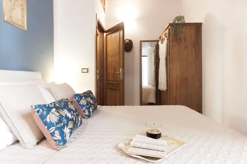 Blue bedroom · double bed and private bathroom doorway