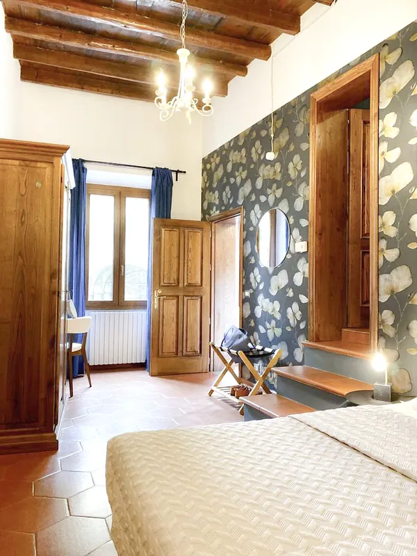 Floral bedroom · bed, window and exposed beams