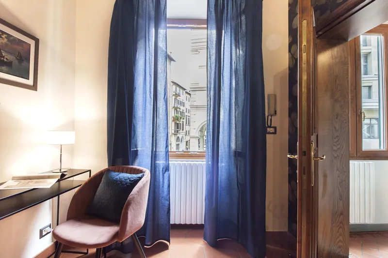 Floral bedroom · window and armchair